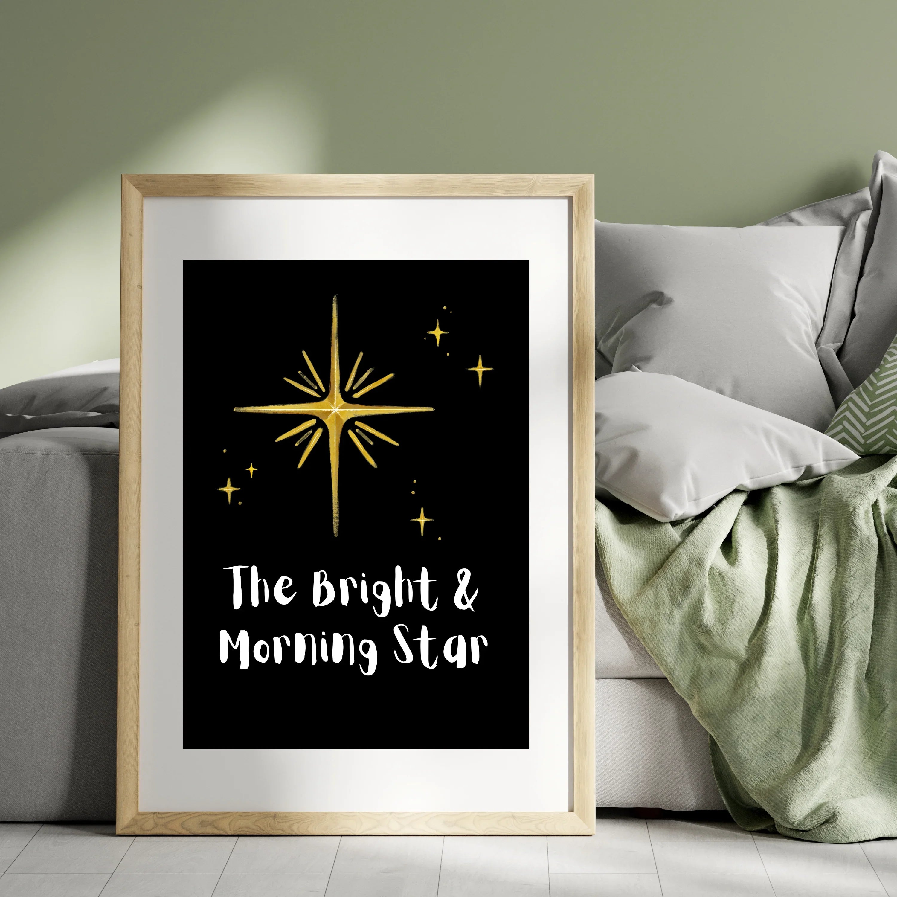 The Bright & Morning Star poster design with gold star illustration in wooden frame beside sofa A1 Business-Hub